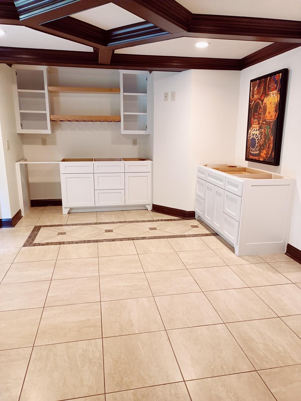 Built-in shelving beneath a coffered ceiling